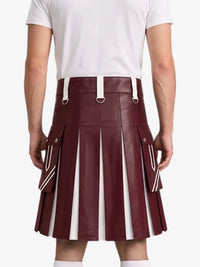 A maroon faux-leather pleated kilt with white stripe details and white belt loops, shown on a model from the back wearing a white t-shirt.