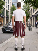 A man stands on a city sidewalk facing away from the camera, wearing a white t-shirt and a pleated burgundy leather kilt with white vertical stripe details, white knee-high socks, and black shoes. A black Mercedes-Benz car and a bicycle are visible in the background.