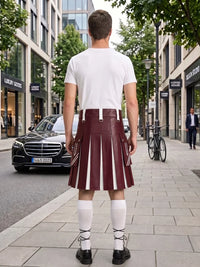 A man stands on a city sidewalk facing away from the camera, wearing a white t-shirt and a pleated burgundy leather kilt with white vertical stripe details, white knee-high socks, and black shoes. A black Mercedes-Benz car and a bicycle are visible in the background.