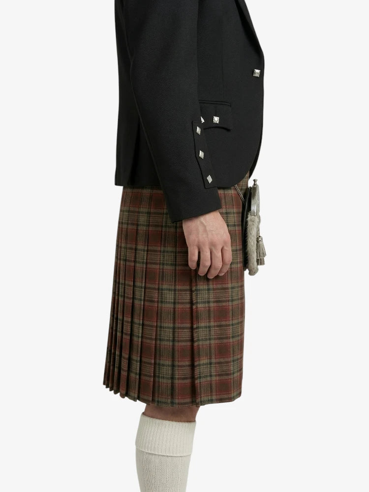 Person wearing a black jacket and plaid kilt on a white background