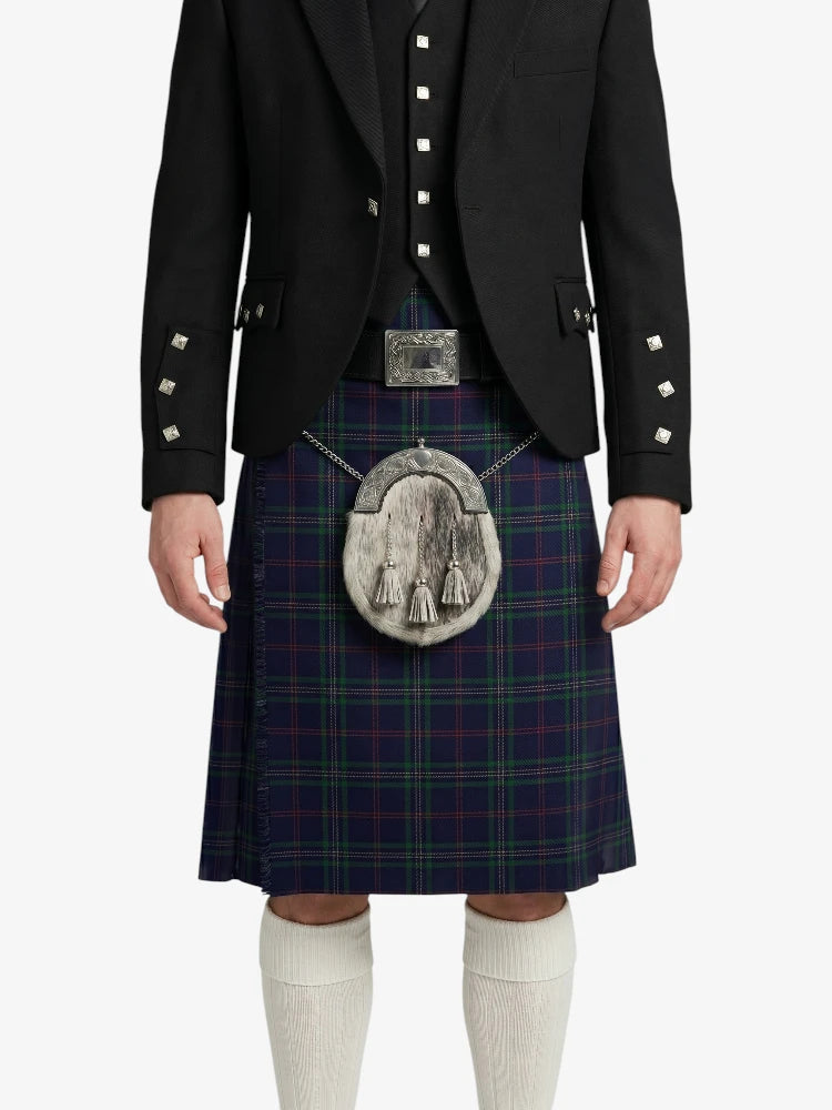 Person wearing a traditional Scottish kilt with a jacket on a white background