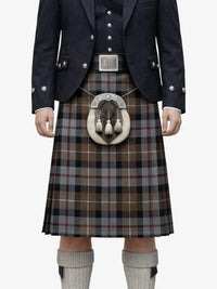 Traditional Scottish kilt with a dark jacket and white belt on a white background