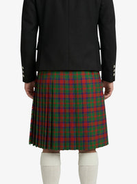 Person wearing a black jacket and red and green plaid kilt on a white background