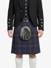 Person wearing a black jacket with white buttons, a blue plaid kilt, and white knee-high socks on a white background.
