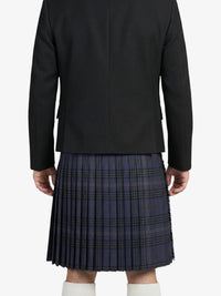 Person wearing a black blazer and plaid kilt on a white background
