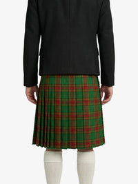 Person wearing a black jacket and green plaid skirt on a white background