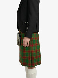 Person wearing a black jacket and green plaid kilt on a white background