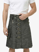 Person wearing a gray kilt with metal buckles on a white background