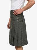 Gray kilt worn by a person on a white background