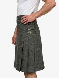 Gray kilt worn by a person on a white background