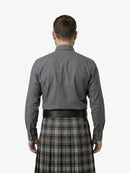 Man wearing a gray shirt and plaid kilt on a white background