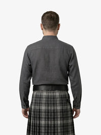 Man wearing a dark shirt and plaid kilt on a white background