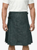 Man wearing a dark denim kilt on a white background