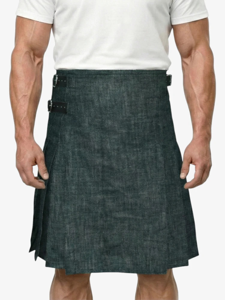 Man wearing a dark denim kilt on a white background