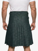 Person wearing a green pleated kilt on a white background