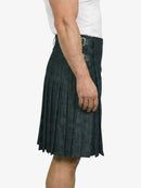 Person wearing a dark denim kilt on a white background