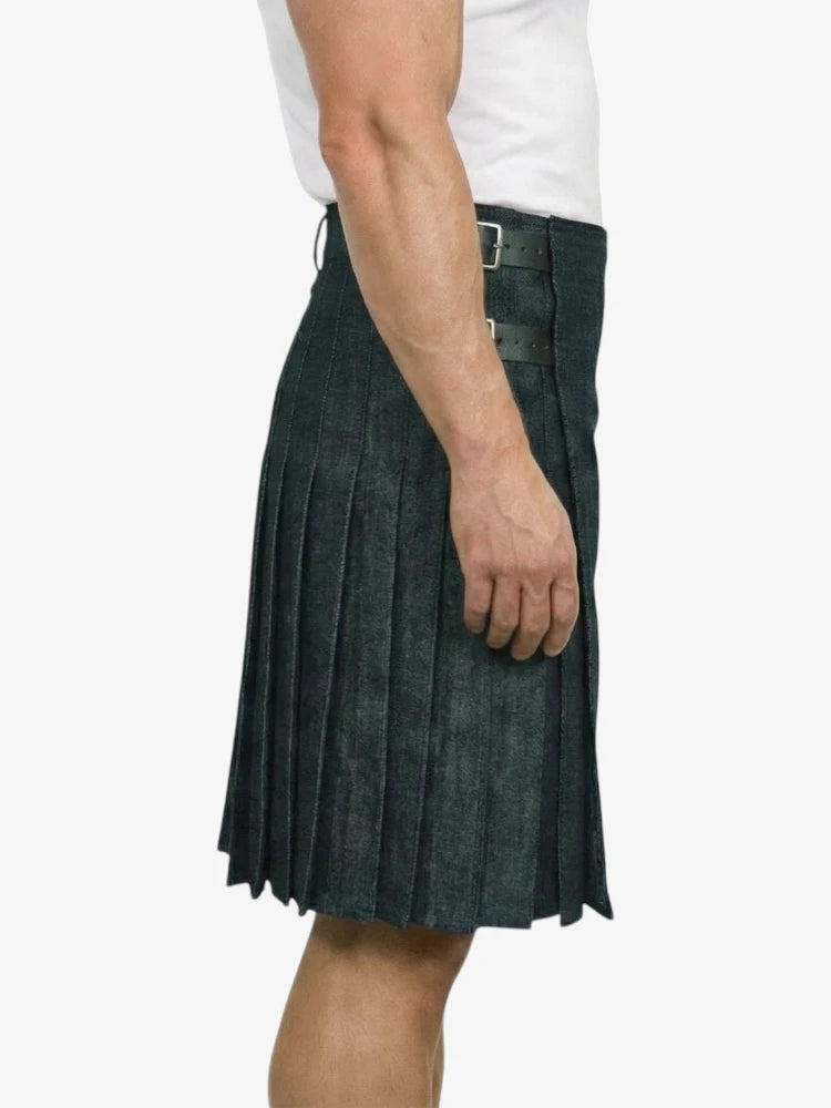Person wearing a dark denim kilt on a white background