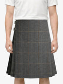 Person wearing a gray checkered skirt on a white background
