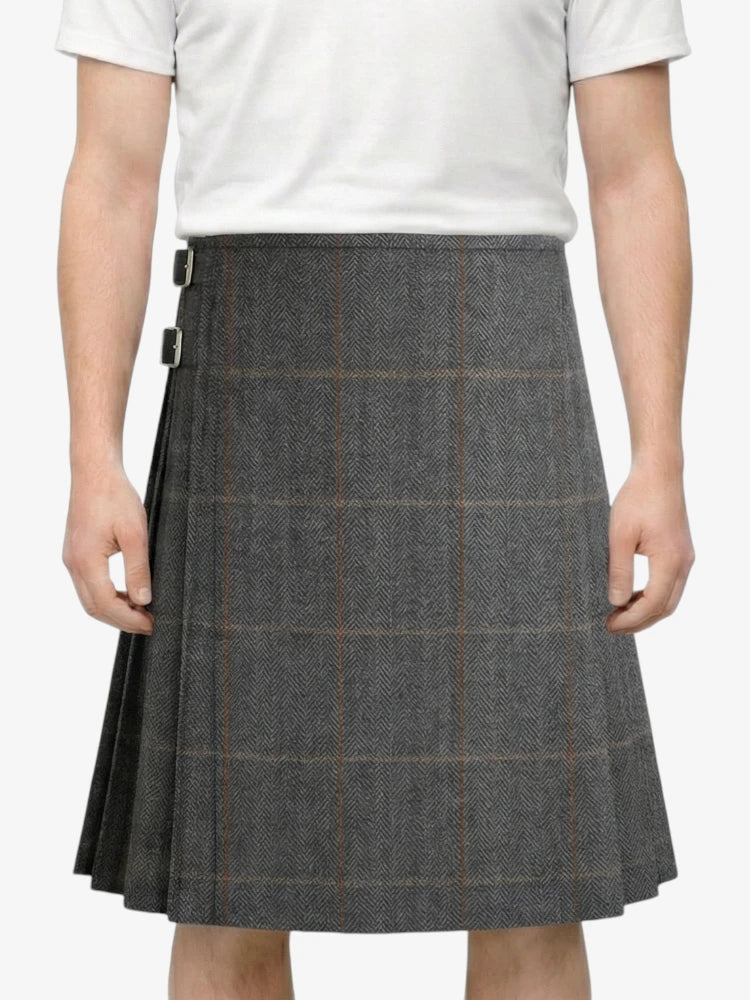 Person wearing a gray checkered skirt on a white background