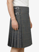 Gray plaid kilt worn by a person on a white background