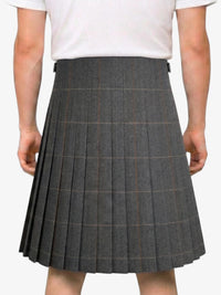 Person wearing a gray pleated skirt on a white background