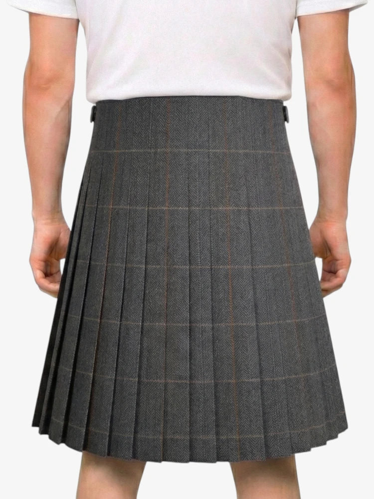 Person wearing a gray pleated skirt on a white background