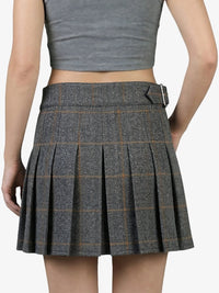 Plaid skirt worn by a person on a white background