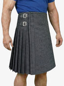 Gray pleated kilt worn by a person on a white background