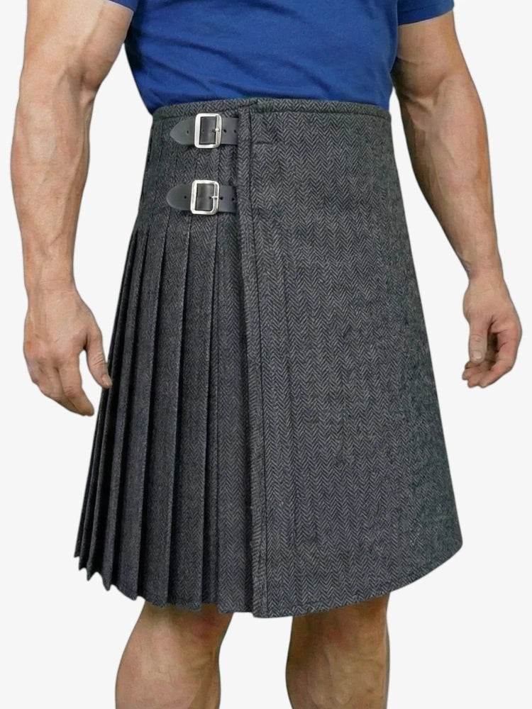 Gray pleated kilt worn by a person on a white background