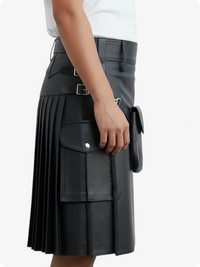 Black pleated skirt with silver buckles worn by a person on a white background