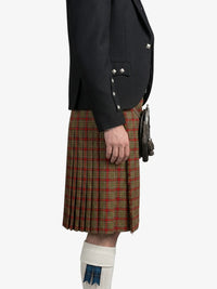 Person wearing a black jacket and red plaid kilt on a white background