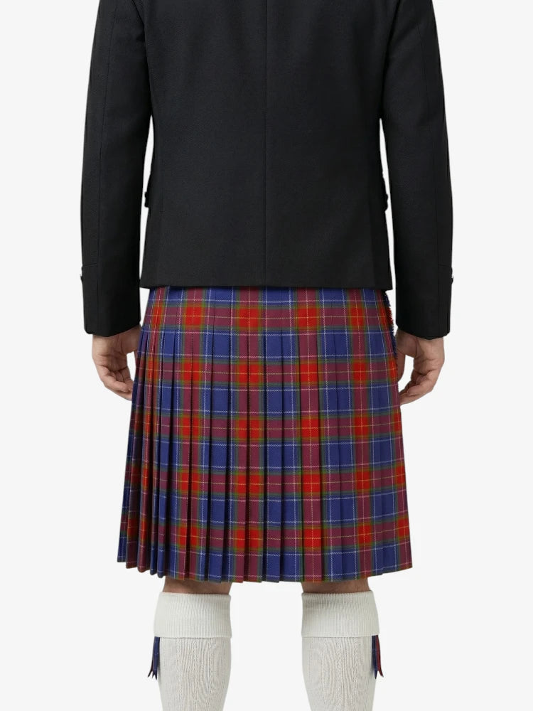 Person wearing a black jacket and red, blue, and green plaid kilt on a white background