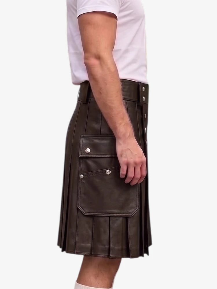 A side view of a person wearing a dark brown faux-leather kilt with pleats, flap pockets with silver snap buttons, and a matching belt, paired with a white t-shirt against a light gray background.