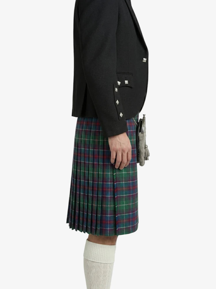 Person wearing a black blazer and plaid kilt on a white background