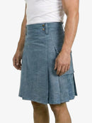 Person wearing a blue denim kilt on a white background