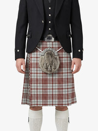 Traditional Scottish kilt with a tartan pattern worn by a person on a white background