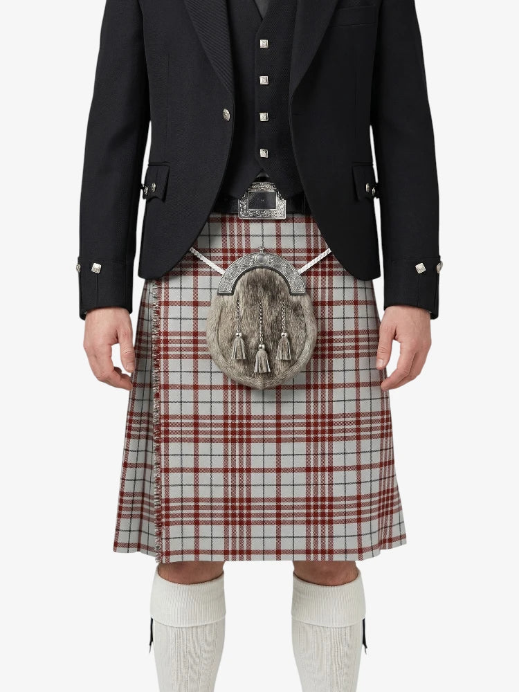 Traditional Scottish kilt with a tartan pattern worn by a person on a white background