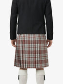 Person wearing a black jacket and plaid kilt on a white background