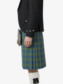 Person wearing a black jacket and blue plaid kilt on a white background