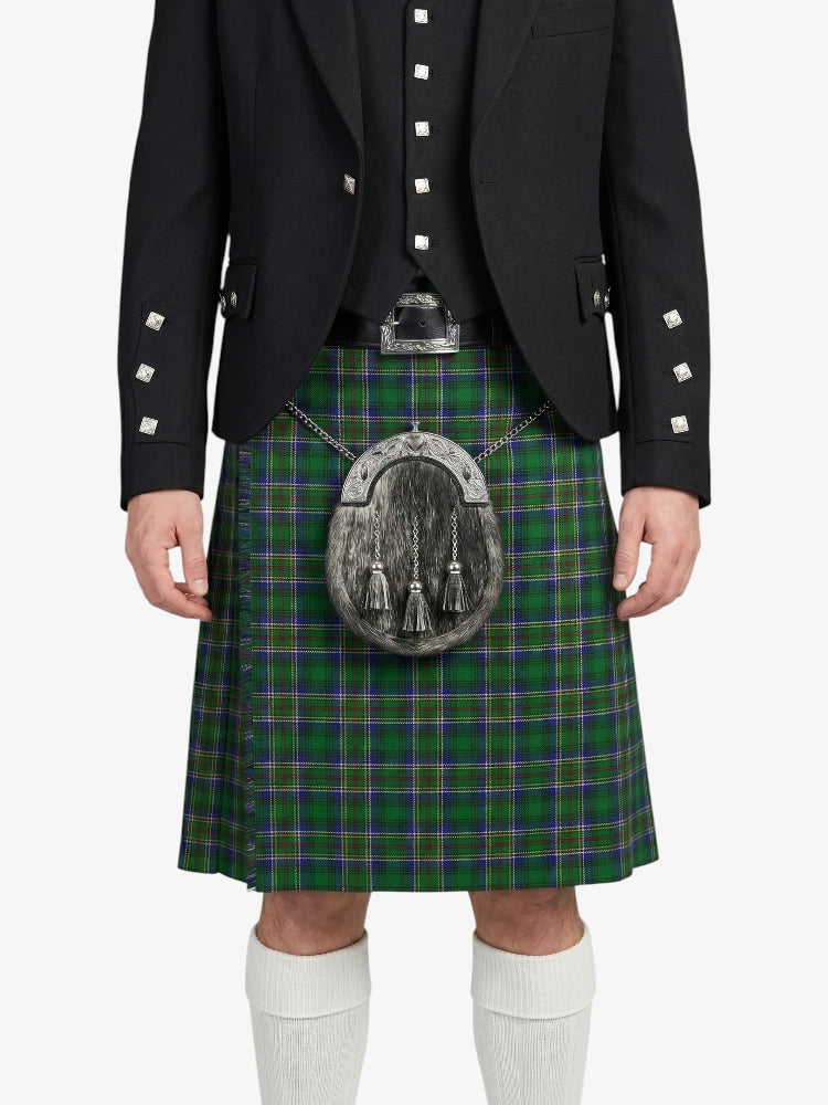 Person wearing a black jacket and green plaid kilt on a white background