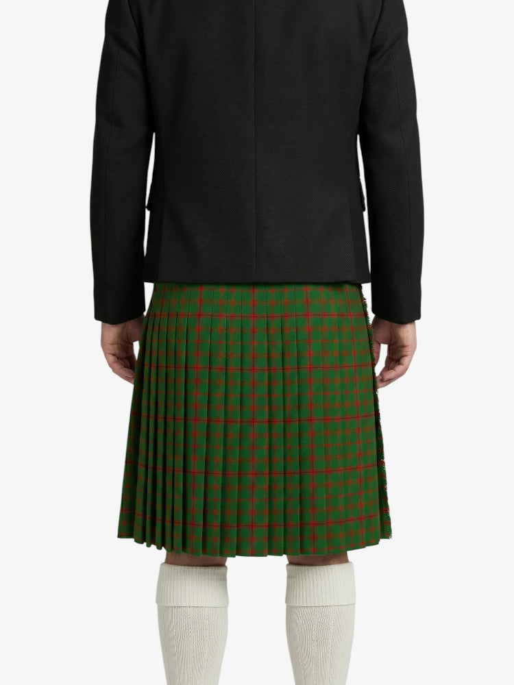 Person wearing a black jacket and green plaid kilt on a white background
