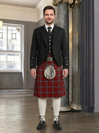 Man wearing a traditional Scottish kilt in an elegant interior setting