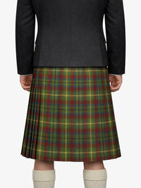 Person wearing a dark gray jacket and a plaid kilt on a white background