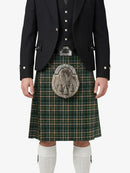 Person wearing a traditional Scottish kilt with a tartan pattern on a white background