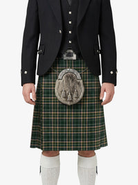 Person wearing a traditional Scottish kilt with a tartan pattern on a white background