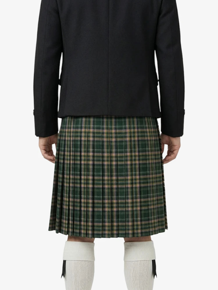 Person wearing a black jacket and green plaid skirt on a white background