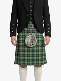 Person wearing a green plaid kilt with a black jacket on a white background
