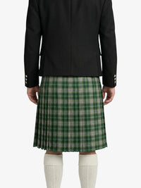 Person wearing a black jacket and green plaid kilt on a white background