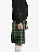 Person wearing a black blazer and green plaid kilt on a white background