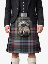 Person wearing a traditional Scottish kilt with a jacket and white socks on a white background